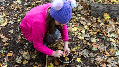 Girl playing with mud kitchen